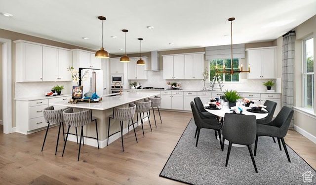 623 S 230 W Unit 3, Ivins, UT 84738 - kitchen featuring wall chimney exhaust hood, white cabinets, a sink, white appliances, and a kitchen breakfast bar