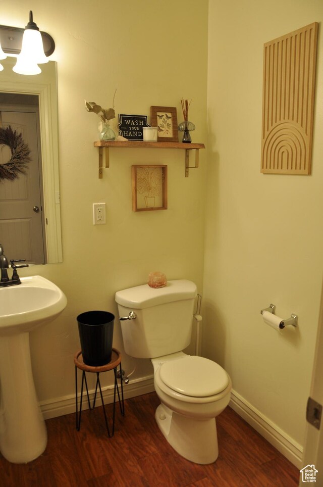 10611 S Oquirrh Lake Rd W, South Jordan, UT 84009 - bathroom featuring baseboards, wood finished floors, a sink, and toilet