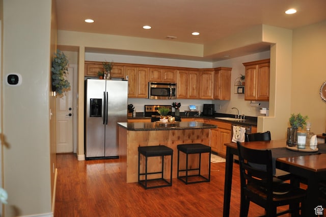 10611 S Oquirrh Lake Rd W, South Jordan, UT 84009 - kitchen featuring stainless steel appliances, a center island, dark countertops, and dark wood finished floors