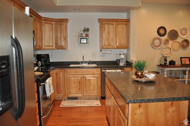 10611 S Oquirrh Lake Rd W, South Jordan, UT 84009 - kitchen featuring dark countertops, wood finished floors, a sink, a center island, and appliances with stainless steel finishes