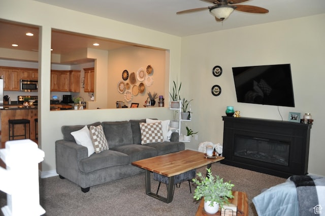 10611 S Oquirrh Lake Rd W, South Jordan, UT 84009 - carpeted living room featuring a ceiling fan, a glass covered fireplace, and recessed lighting