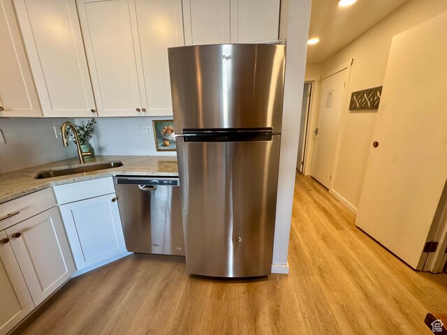 2176 S Bear Blvd Unit 316, & Garden City, UT 84028 - kitchen with stainless steel appliances, light wood-type flooring, white cabinets, and a sink