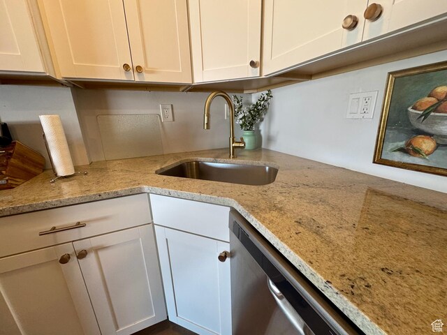 2176 S Bear Blvd Unit 316, & Garden City, UT 84028 - kitchen featuring stainless steel dishwasher, a sink, white cabinets, and light stone countertops