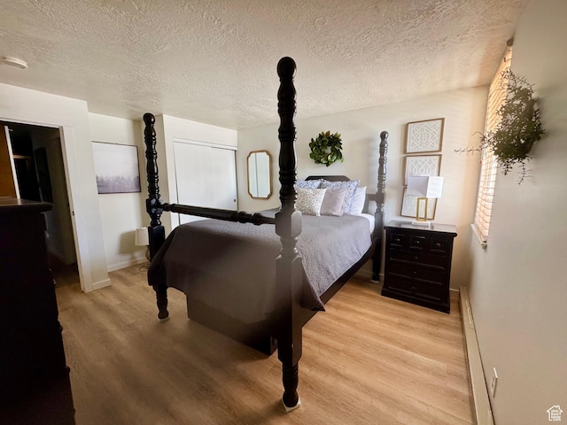 2176 S Bear Blvd Unit 316, & Garden City, UT 84028 - bedroom featuring baseboards, a textured ceiling, and light wood finished floors