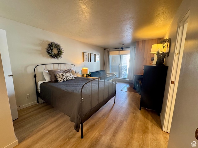 2176 S Bear Blvd Unit 316, & Garden City, UT 84028 - bedroom featuring light wood finished floors, baseboards, and a textured ceiling
