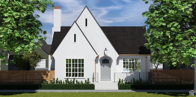 441 S Main St Unit 135, Vineyard, UT 84058 - view of front of house featuring a shingled roof, a chimney, fence, and stucco siding