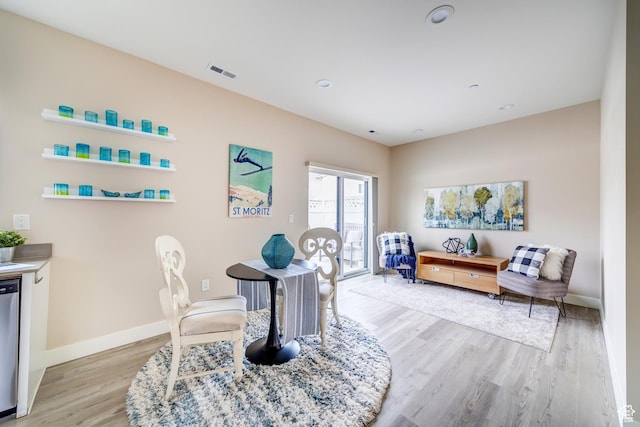 office featuring baseboards, light wood-style floors, and visible vents