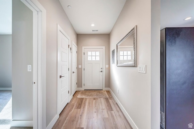 doorway to outside featuring recessed lighting, baseboards, and light wood-type flooring