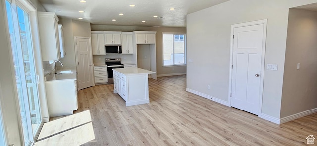 3392 E Stillwater, Eagle Mountain, UT 84005 - kitchen featuring a sink, baseboards, stainless steel appliances, recessed lighting, and white cabinetry