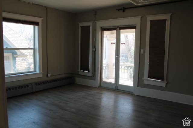 653 E 300 S, Salt Lake City, UT 84102 - empty room with a baseboard heating unit and wood finished floors