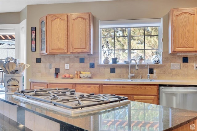 243 Eastridge E, Logan, UT 84321 - kitchen featuring tasteful backsplash, appliances with stainless steel finishes, light countertops, light brown cabinetry, and a sink