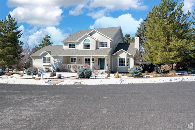 243 Eastridge E, Logan, UT 84321 - view of front of home with a porch and a chimney