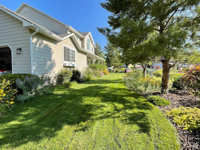 243 Eastridge E, Logan, UT 84321 - view of yard featuring an attached garage