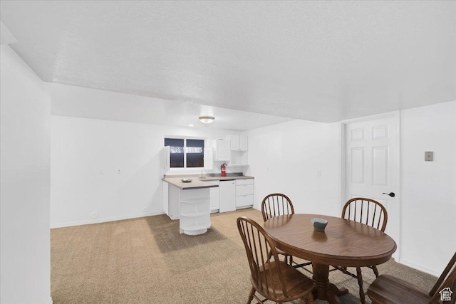 243 Eastridge E, Logan, UT 84321 - dining area with baseboards, a textured ceiling, and light colored carpet