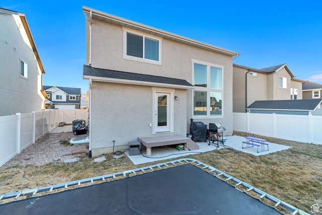 back of property featuring a patio, roof with shingles, a fenced backyard, and stucco siding