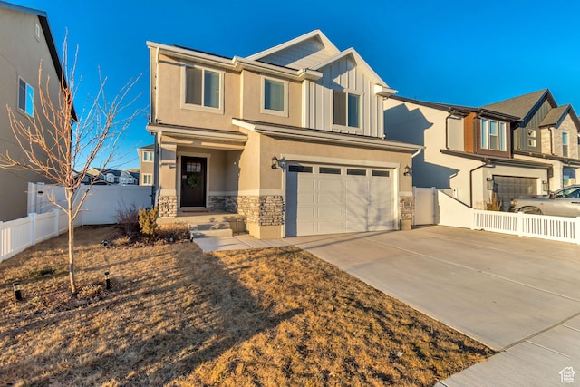 view of front of property with an attached garage, stone siding, fence, and concrete driveway