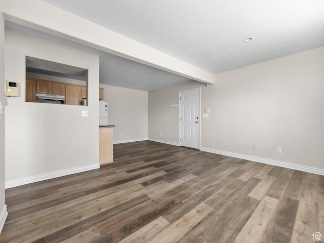 177 S 1050 W Unit 19, Provo, UT 84601 - unfurnished living room featuring dark wood finished floors, beam ceiling, and baseboards