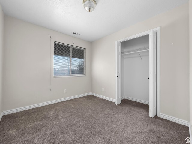 177 S 1050 W Unit 19, Provo, UT 84601 - unfurnished bedroom featuring a closet, visible vents, carpet flooring, a textured ceiling, and baseboards