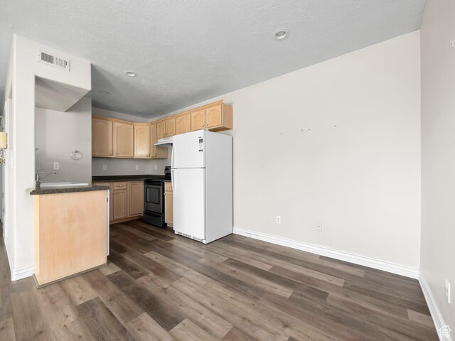 177 S 1050 W Unit 19, Provo, UT 84601 - kitchen with dark wood-style floors, dark countertops, visible vents, black range with electric stovetop, and freestanding refrigerator
