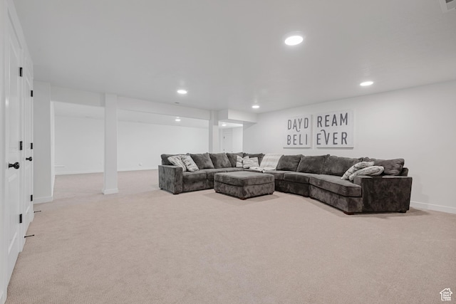 carpeted living area featuring baseboards and recessed lighting