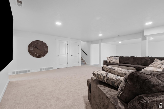 carpeted living room with stairs, visible vents, and recessed lighting