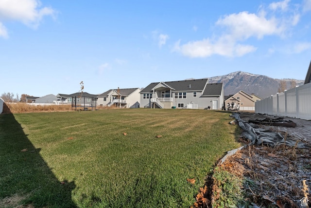 view of yard with a residential view and fence