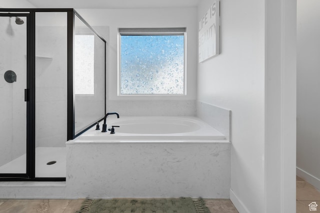 full bath with a shower stall and a bath