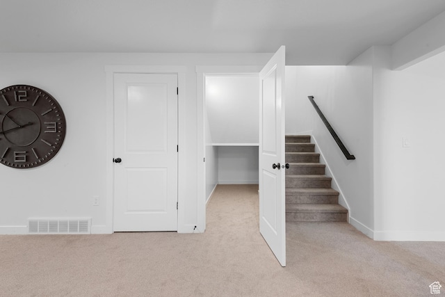 interior space with stairs, carpet, visible vents, and baseboards