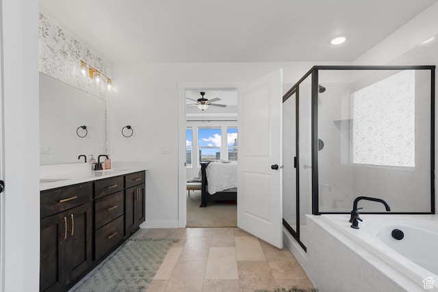 bathroom featuring a stall shower, a sink, a bath, and double vanity
