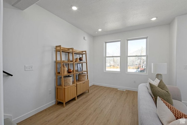 277 W 430 N Unit 1-03, Salt Lake City, UT 84103 - living area featuring light wood-style floors, baseboards, a textured ceiling, and recessed lighting