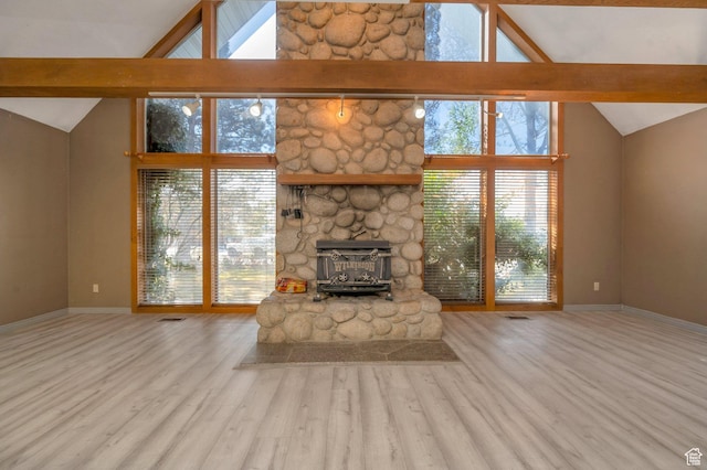 unfurnished living room with beamed ceiling, baseboards, a fireplace, wood finished floors, and high vaulted ceiling
