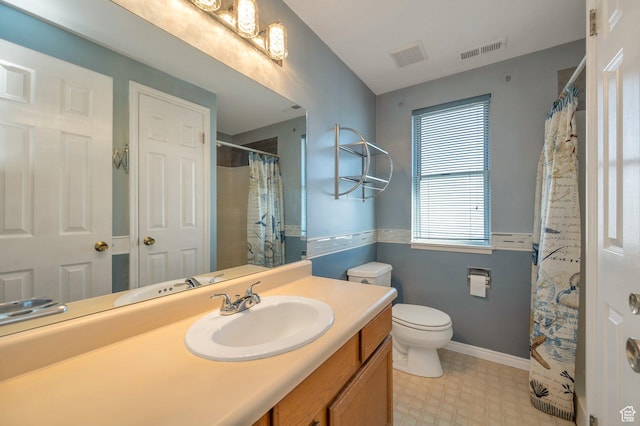 bathroom with toilet, tile patterned floors, visible vents, and vanity