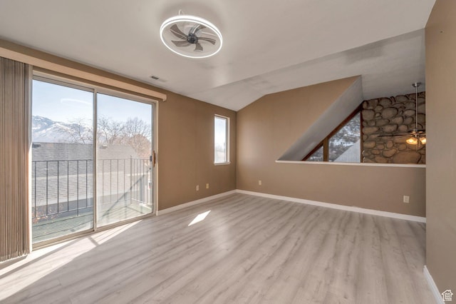 unfurnished living room with wood finished floors, a ceiling fan, visible vents, and baseboards
