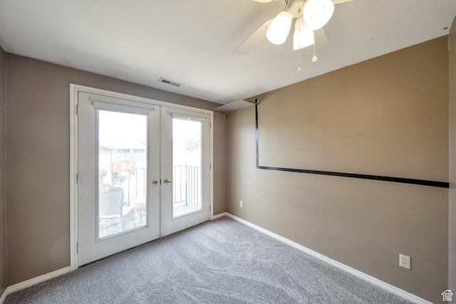 unfurnished room featuring carpet, baseboards, visible vents, a ceiling fan, and french doors