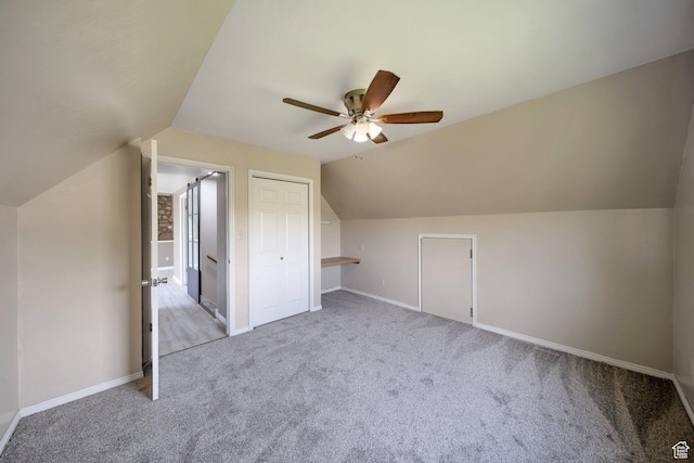 bonus room with a ceiling fan, vaulted ceiling, carpet floors, and baseboards