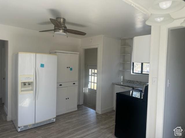 143 N 150 W, Tooele, UT 84074 - kitchen with open shelves, a ceiling fan, white cabinets, white fridge with ice dispenser, and light wood-type flooring