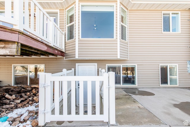 rear view of property with a fenced front yard and a patio area