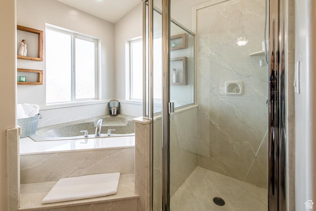 full bathroom with a marble finish shower and a bath