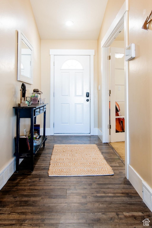 doorway with baseboards and dark wood finished floors
