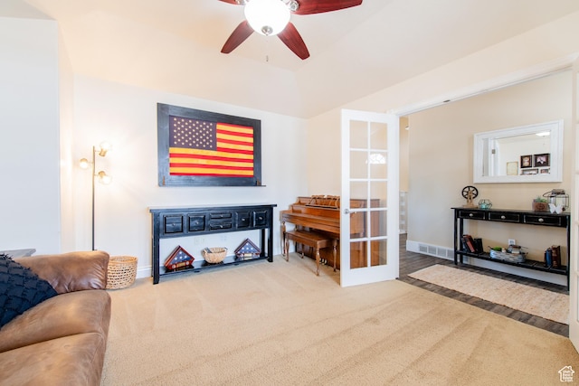carpeted living area with baseboards, visible vents, a ceiling fan, and french doors