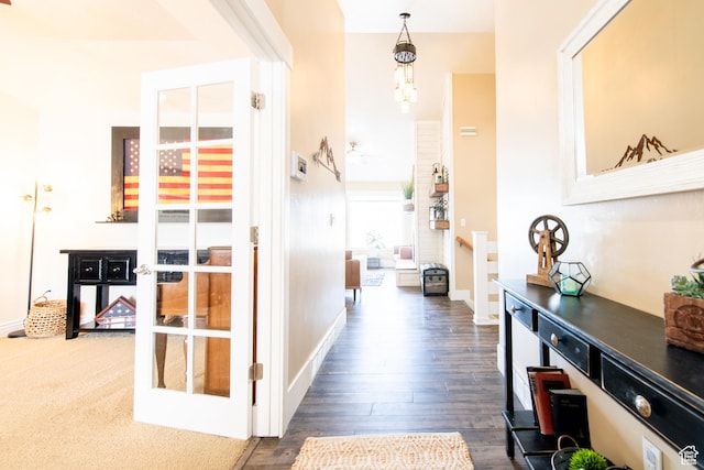 hallway with french doors, baseboards, and wood finished floors