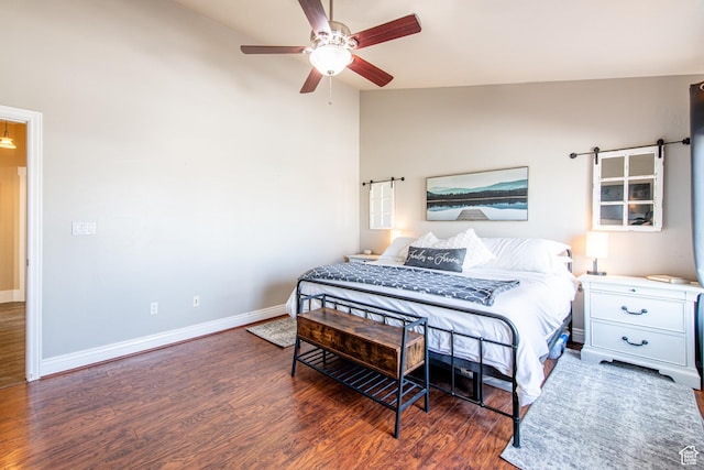 bedroom with lofted ceiling, ceiling fan, baseboards, and wood finished floors