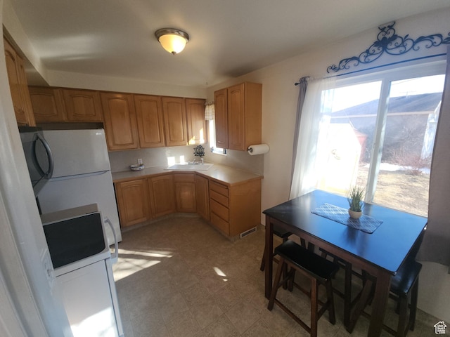 1105 9th St, Ogden, UT 84404 - kitchen with freestanding refrigerator and light flooring