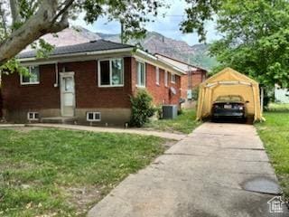 1105 9th St, Ogden, UT 84404 - view of front of home featuring a front lawn, concrete driveway, and a detached carport