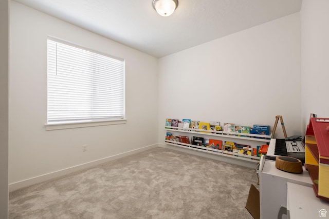 recreation room with carpet and baseboards