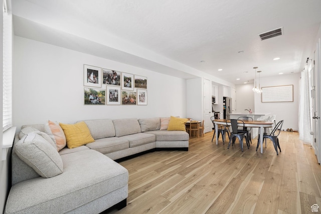 living area featuring light wood-style floors, visible vents, and recessed lighting