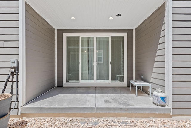 view of exterior entry featuring a patio area