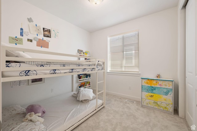 bedroom featuring light carpet, visible vents, and baseboards