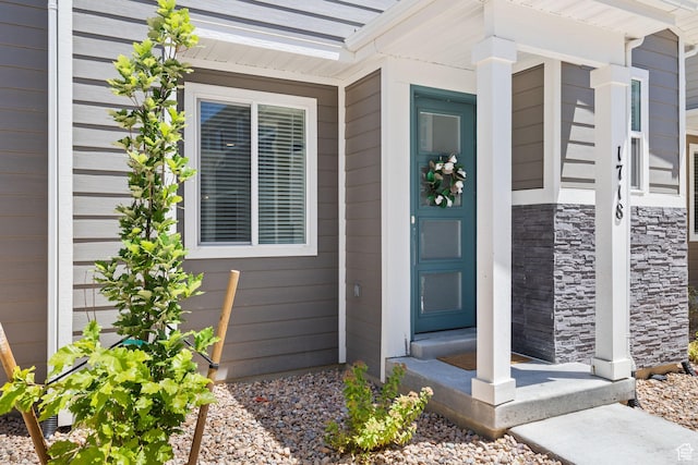 property entrance with stone siding