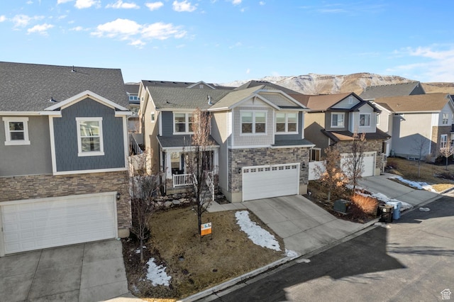 4927 W Yellow Topaz Dr, Herriman, UT 84096 - view of front of property featuring a mountain view, a garage, a residential view, stone siding, and driveway